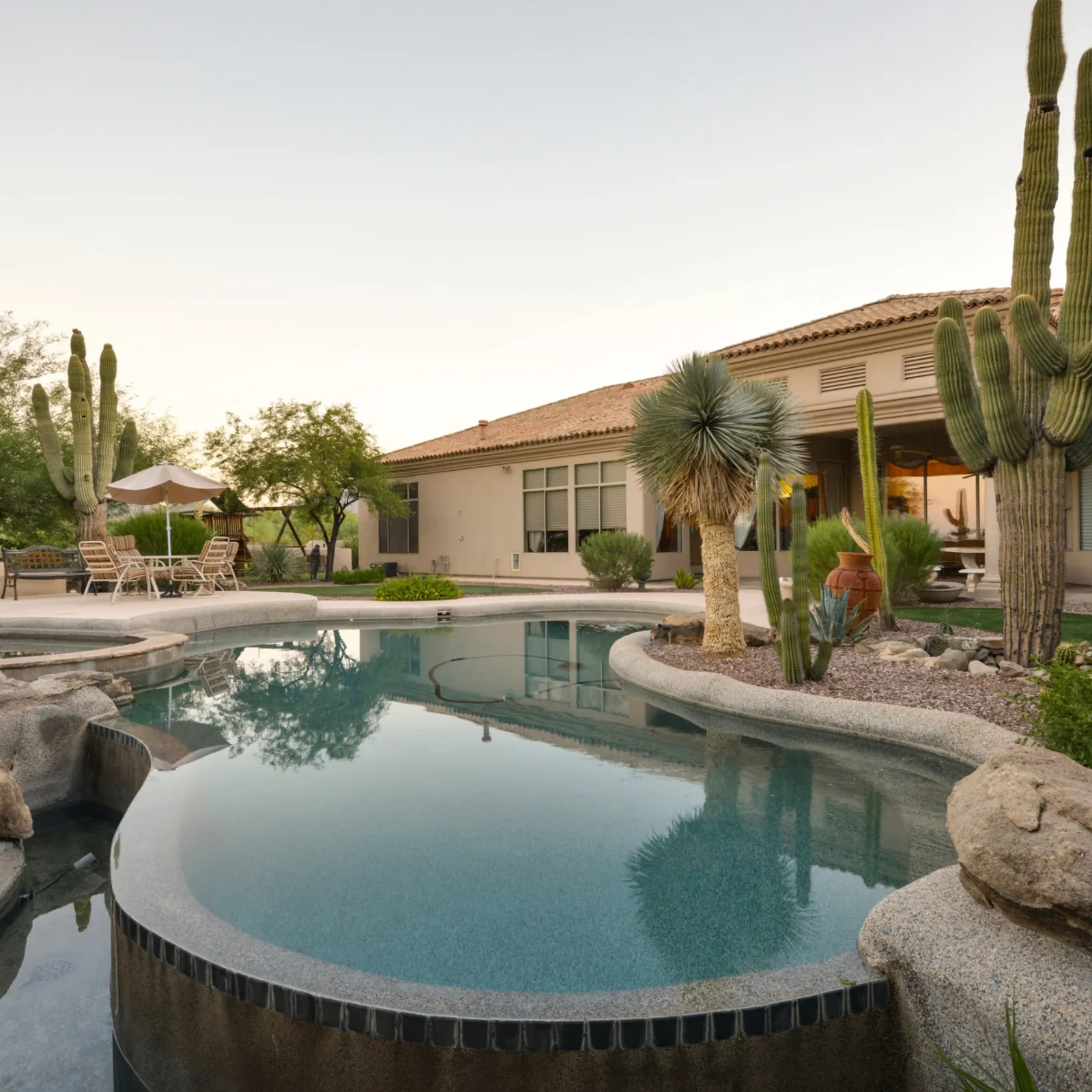 Crystal clear backyard pool with waterfall feature